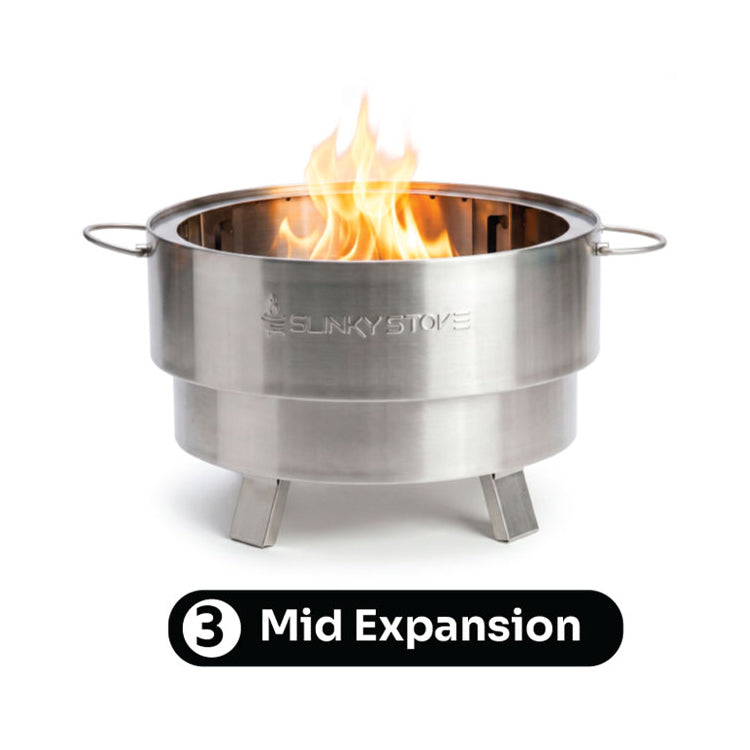Slinky Stove fire pit at its middle 14-inch expansion level with flames.